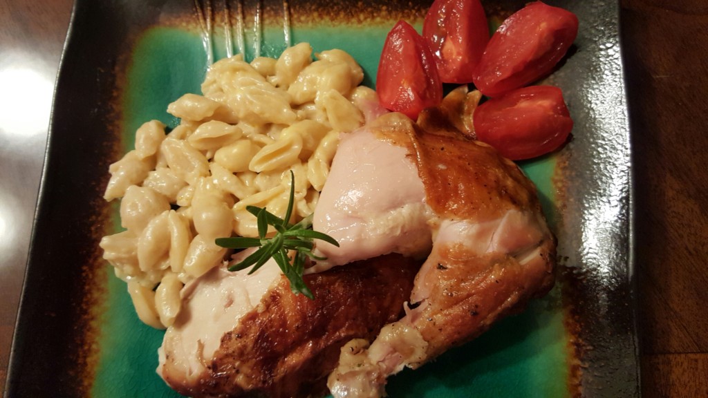 creamy homemade mac and cheese with rotisserie chicken and sliced tomatoes 