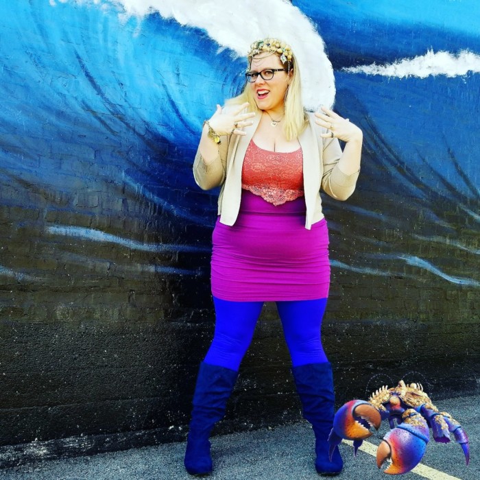 Chrissy in tamatoa Disneybound outfit in front of a mural wall