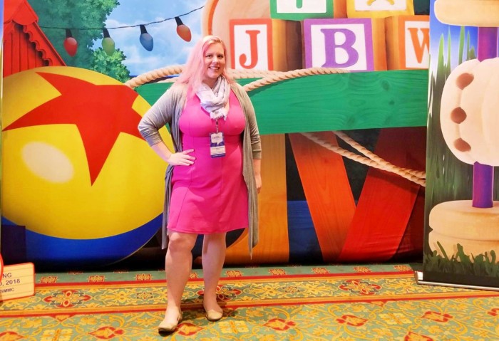 Chrissy disneybounding as Mrs. Hopps in front of Toy Story Land display at Disney Social Media Moms On the Road Conference
