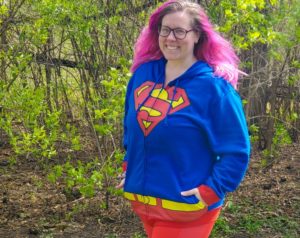 Chrissy posing in a Superman hoodie